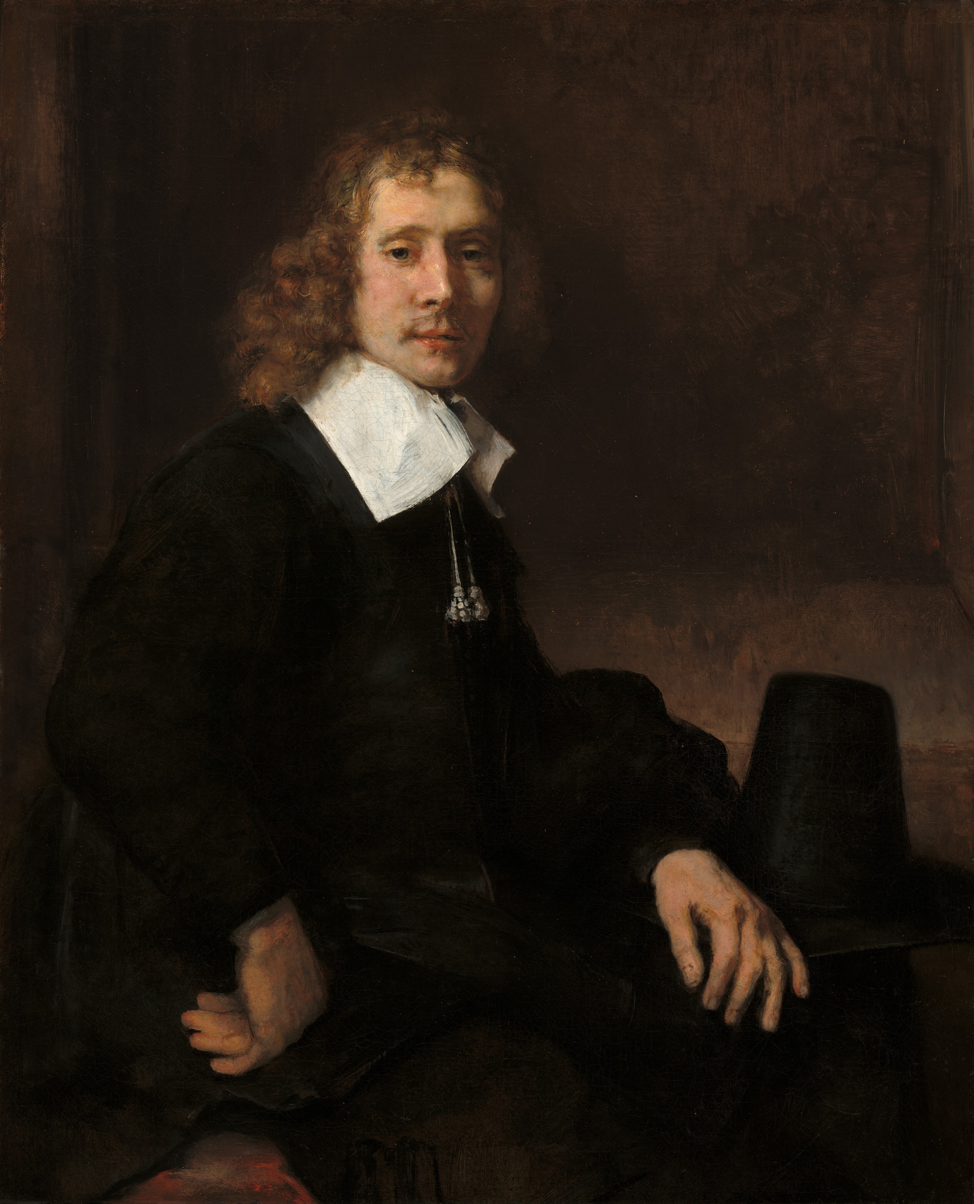 A Young Man Seated at a Table (possibly Govaert Flinck) by Rembrandt van Rijn